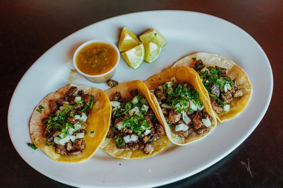 Street tacos with onion, cilantro, salsa, and lime